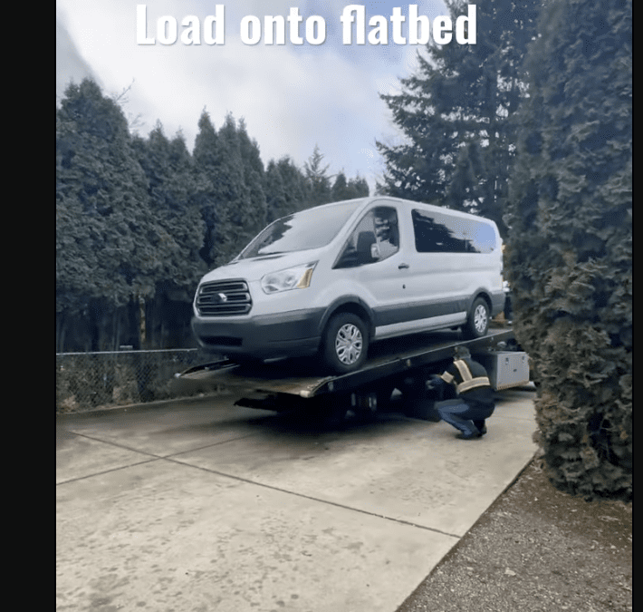 Loading onto flatbed- by Tow World Towing in Renton, WA